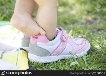 childrens feet in a park