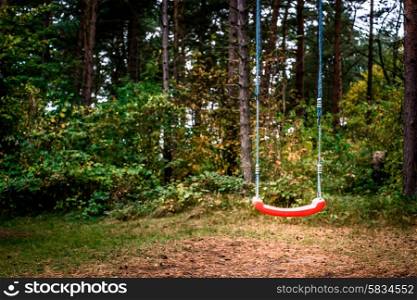 Childrens playground swing in the middle of the forest