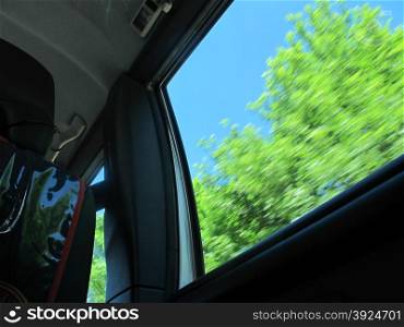 Childs view out of a driving car. Childs view from the back seat out of a driving car