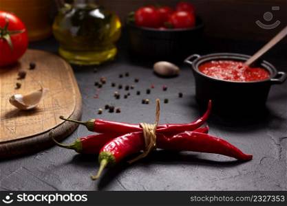Chile pepper and tomato sauce ingredient for homemade cooking on table. Recipe concept in kitchen