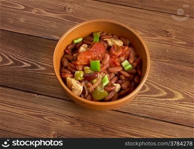 Chili con carne - in American English as simply ?chili?, is a spicy stew containing chili peppers, meat (usually beef), tomatoes and often beans