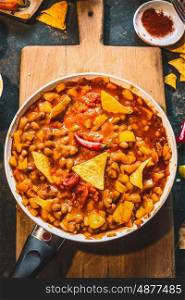 Chili Con Carne in cooking pan with tortilla chips , top view