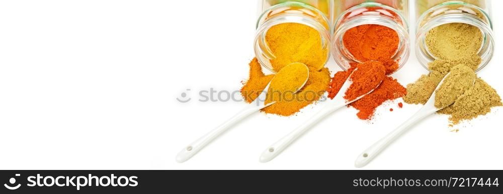 Chili, curry and turmeric powder isolated on white background. Wide photo. Free space for text.