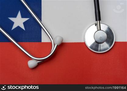 Chili flag and stethoscope. The concept of medicine. Stethoscope on the flag in the background.. Chili flag and stethoscope. The concept of medicine.