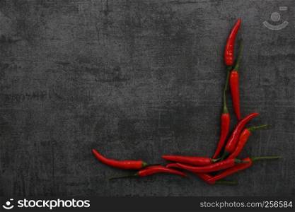 Chili pepper on dark rock background
