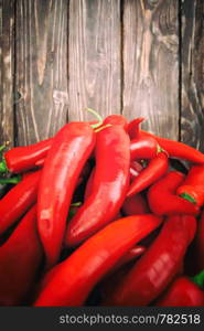 chili pepper on wood background. Red hot chili peppers on wood background