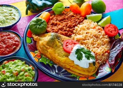 Chili relleno chili pepper poblano filled with cheese in dish with with rice and frijoles beans