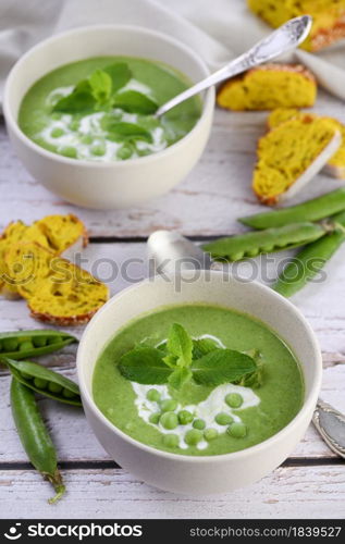 Chilled soup puree of green peas, seasoned with green onion, mint and crunchy toasted diced rusk bread