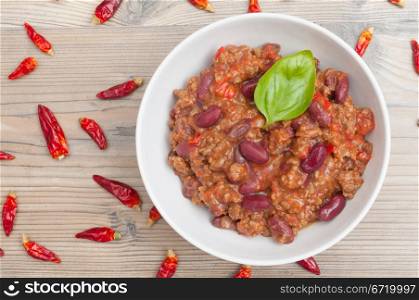Chilli Con Carne in White Bowl and Chili Peppers