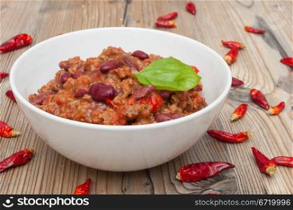 Chilli Con Carne in White Bowl and Red Chili Peppers