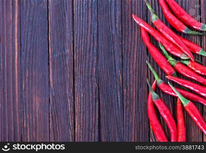 chilli peppers on the wooden table, hot chilli
