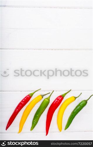 Chilli peppers on wooden background. Studio photo. Chilli peppers on wooden background