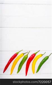 Chilli peppers on wooden background. Studio photo. Chilli peppers on wooden background