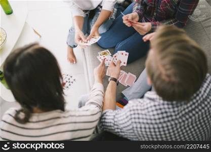 chilling people playing cards sofa