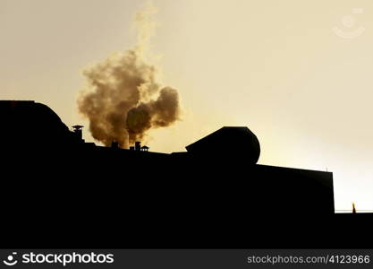 Chimeney on an industrial factory, smoke backlight