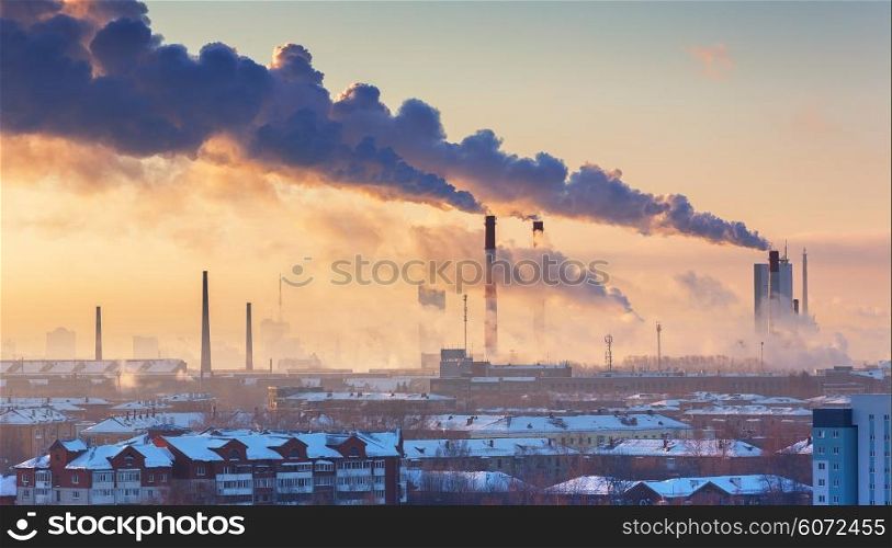 chimneys with smoke in the city at morning