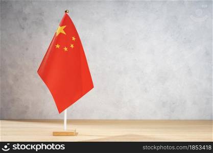China table flag on white textured wall. Copy space for text, designs or drawings
