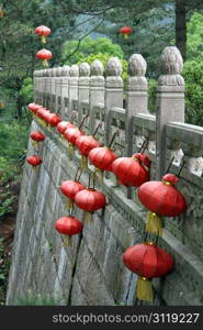 Chineae red lamps and stone wall of buddhist temple in Jiuhua Shan, China