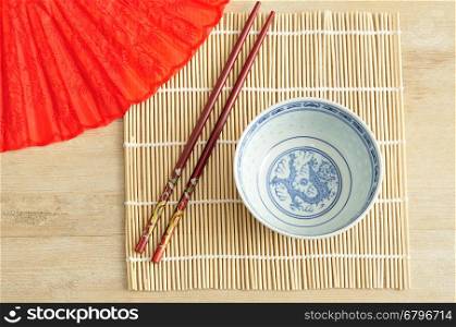 Chines bowl, chopsticks and a hand fan