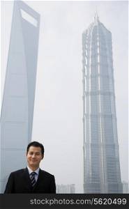 Chinese businessman near skyscrapers