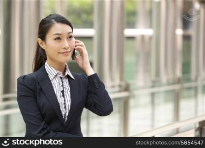 Chinese Businesswoman Outside Office On Mobile Phone