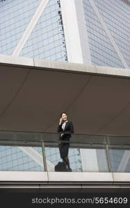 Chinese Businesswoman Outside Office On Mobile Phone