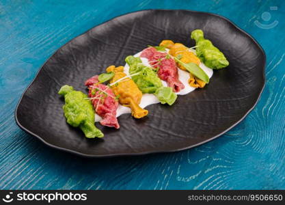 Chinese colourful steamed dumplings on black plate