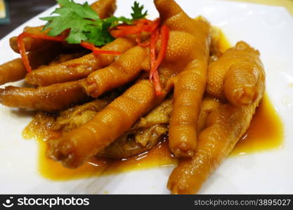 Chinese cooked chicken feet in a white plate