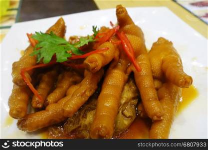 Chinese cooked chicken feet in a white plate