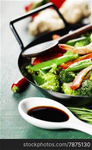 Chinese cuisine. Colorful stir fry in a wok. Shrimps with vegetables