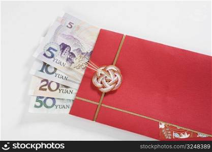 Chinese currency in a red envelope