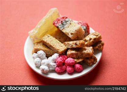 Chinese desserts, Snack mix nuts candies sweets sugar sliced nuts sesame seeds coated beans grains puffed rice candied winter melon, Thai and chinese pay respect to god in chinese new year festival
