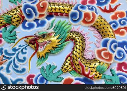 chinese dragon on the wall of shrine with beautiful sky background