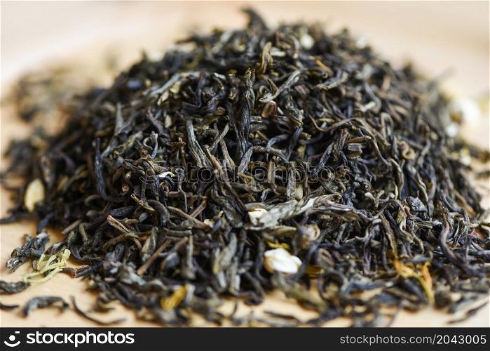 Chinese dry tea on wooden background, jasmine tea dried for brew tea, leaf black tea