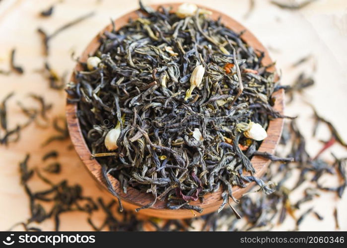 Chinese dry tea on wooden bowl, jasmine tea dried for brew tea, leaf black tea