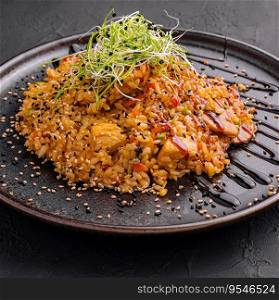 chinese fried rice with chicken on black plate