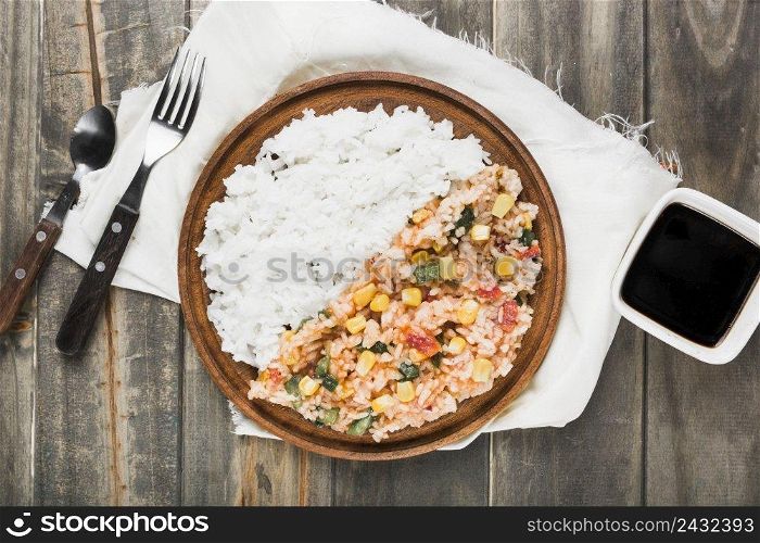 chinese fried steamed rice wooden plate with soya sauce table