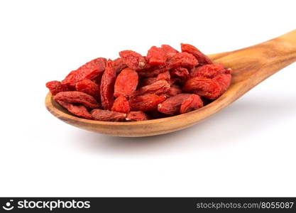 Chinese goji berries in wooden spoon close up on white background