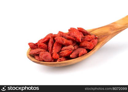 Chinese goji berries in wooden spoon close up on white background