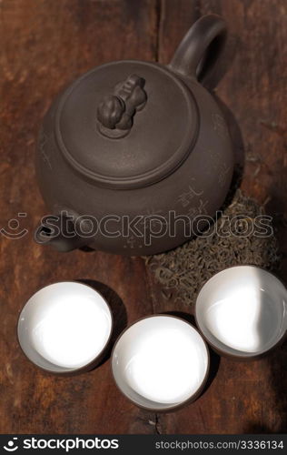 chinese green tea traditional pot and cups over old wood board