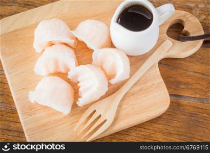 Chinese har gao dim sum dumplings on wooden plate, stock photo