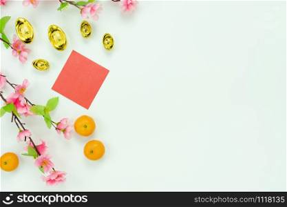Chinese language mean rich or wealthy and happy.Top view decoration Chinese new year & lunar new year holiday background concept.Flat lay orange with pink flower on white wooden at home office desk.