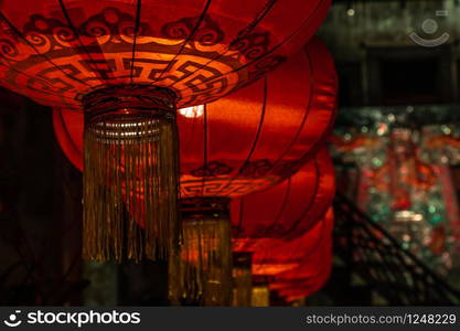 Chinese lantern & light bulb on dark background. The interior asian decorations. Selective focus.