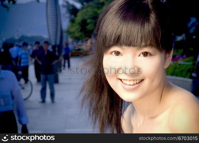 Chinese models pose for a beauty head shot and look very innocent.