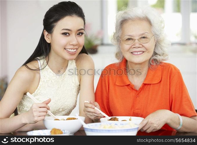 Chinese Mother And Adult Daughter Eating Meal Together