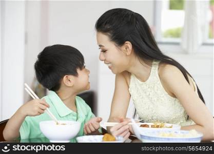 Chinese Mother And Son Sitting At Home Eating A Meal