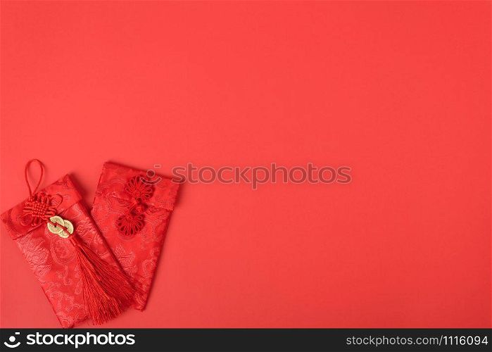 "Chinese new year festival concept, flat lay top view, Happy Chinese new year with Red envelope (Character "FU" means fortune, blessing, wealth) on red background with copy space for your text"