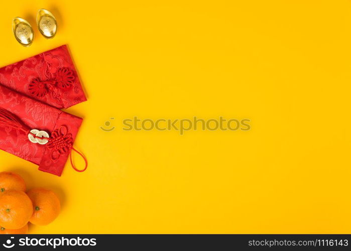 "Chinese new year festival concept, flat lay top view, Happy Chinese new year with Red envelope and gold ingot (Character "FU" means fortune, blessing) on yellow background with copy space for text"
