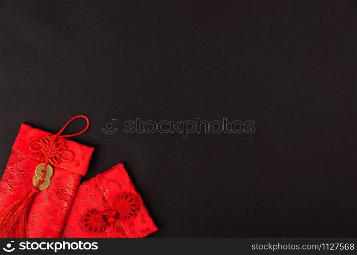 "Chinese new year festival concept, flat lay top view, Happy Chinese new year with Red envelope (Character "FU" means fortune, blessing, wealth) on black background with copy space for your text"