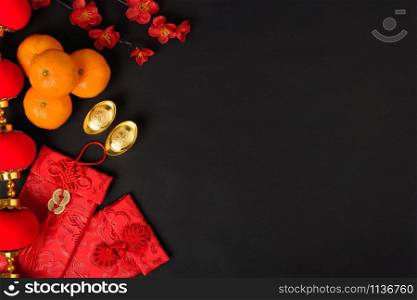 "Chinese new year festival concept, flat lay top view, Happy Chinese new year with Red envelope and gold ingot (Character "FU" means fortune, blessing) on black background with copy space for text"
